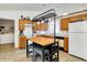 Bright kitchen featuring wood cabinets, tile flooring, butcher block island with seating, and modern appliances at 917 Congressional Way, Shelbyville, IN 46176