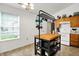 Kitchen with tile floors, a butcher block island with barstool seating, and a bright window at 917 Congressional Way, Shelbyville, IN 46176