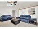 Cozy living room with vaulted ceiling, skylight, neutral carpet, and comfortable blue reclining sofas at 917 Congressional Way, Shelbyville, IN 46176