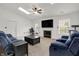 Spacious living room with vaulted ceiling, skylight, neutral carpet, and comfortable furniture arrangement at 917 Congressional Way, Shelbyville, IN 46176