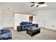 Bright living room with plush seating, neutral carpet, and a view into the kitchen at 917 Congressional Way, Shelbyville, IN 46176