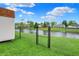 Backyard view of a pond, surrounded by a black chain link fence at 917 Congressional Way, Shelbyville, IN 46176