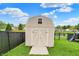 Exterior of a backyard shed with a neutral paint scheme, contrasting trim and well-maintained surrounding lawn at 917 Congressional Way, Shelbyville, IN 46176