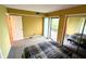 Carpeted bedroom featuring sliding door access to the exterior, closet, and en-suite bathroom at 93 Lookout Ridge Dr # 24U, Columbus, IN 47201