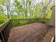 Exterior deck with wood railing overlooking the surrounding lush trees at 93 Lookout Ridge Dr # 24U, Columbus, IN 47201