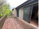 View of the wooden deck with sliding glass doors to the interior at 93 Lookout Ridge Dr # 24U, Columbus, IN 47201