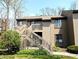 Exterior shot of a two-story home with a stairway leading to the front door and well-maintained landscaping at 93 Lookout Ridge Dr # 24U, Columbus, IN 47201