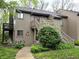 Exterior shot of a home with a stairway leading to the front door and blooming flowers at 93 Lookout Ridge Dr # 24U, Columbus, IN 47201