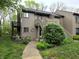Exterior shot of a two-story home with beautiful landscaping and a stairway leading to the entrance at 93 Lookout Ridge Dr # 24U, Columbus, IN 47201