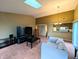 Open-concept living room with a skylight flowing into the dining and kitchen areas at 93 Lookout Ridge Dr # 24U, Columbus, IN 47201