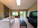 Bright living room featuring a cozy fireplace and sliding glass door to a private patio at 93 Lookout Ridge Dr # 24U, Columbus, IN 47201