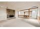 Unfinished basement with a brick fireplace, decorative wood beams, and an adjacent finished area at 101 Applecross Dr, Brownsburg, IN 46112