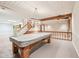 Finished basement featuring a pool table, stairs, and decorative wood beams at 101 Applecross Dr, Brownsburg, IN 46112