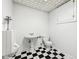 Bathroom with black and white tile flooring, toilet, sink, and urinal at 101 Applecross Dr, Brownsburg, IN 46112