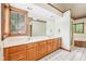 Bathroom featuring dual sinks, large mirror, and tile floors at 101 Applecross Dr, Brownsburg, IN 46112