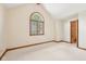 Bedroom featuring a unique arched window, light carpeting and neutral walls with wood trim at 101 Applecross Dr, Brownsburg, IN 46112