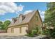 An exterior shot showcases the three car garage with dormer windows above, green landscaping and brick exterior at 101 Applecross Dr, Brownsburg, IN 46112