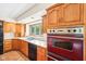 Close-up of a kitchen with stainless steel appliances, wood cabinets, and natural light, combining style and functionality at 101 Applecross Dr, Brownsburg, IN 46112