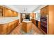 Spacious kitchen features wood cabinets, an island cooktop, and seamless layout into the dining room with natural light at 101 Applecross Dr, Brownsburg, IN 46112