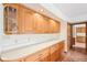 Kitchen featuring long countertops, wood cabinets, and a brick floor at 101 Applecross Dr, Brownsburg, IN 46112