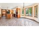 Well-lit kitchen with wood cabinets, stainless steel appliances, and a dining nook with views of the backyard pool at 101 Applecross Dr, Brownsburg, IN 46112