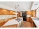 Modern kitchen featuring wood cabinets, central island, and stainless steel appliances, a functional and inviting space at 101 Applecross Dr, Brownsburg, IN 46112