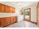 Functional laundry room boasts wood cabinets, washer/dryer units, and a glass door leading to the backyard at 101 Applecross Dr, Brownsburg, IN 46112