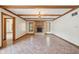 Large living room with beamed ceilings, tile flooring, and a brick fireplace offers cozy ambiance at 101 Applecross Dr, Brownsburg, IN 46112