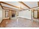 Bright living room with beamed ceilings, tile flooring, and a brick fireplace creates a welcoming space at 101 Applecross Dr, Brownsburg, IN 46112