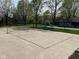 Concrete backyard sport court for tennis or basketball adjoins grassy lawn, slide and pool at 101 Applecross Dr, Brownsburg, IN 46112