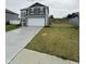 Charming two-story home with gray siding, white trim, and a spacious concrete driveway at 10931 N Longbranch St, Monrovia, IN 46157