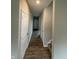 Hallway featuring wood-look floors, neutral paint, and white trim at 10931 N Longbranch St, Monrovia, IN 46157