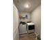 Functional laundry room featuring modern gray appliances and wood-look flooring at 10931 N Longbranch St, Monrovia, IN 46157