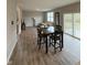 Open floor plan with living and dining area featuring wood-look floors at 10931 N Longbranch St, Monrovia, IN 46157
