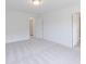A spacious bedroom featuring plush carpet, bright windows, and access to the bathrooms at 1107 Stubble Run, Danville, IN 46122