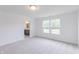 Neutral bedroom featuring carpet, two bright windows, and access to a bathroom with natural light at 1107 Stubble Run, Danville, IN 46122