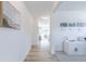 Hallway leading into a bright living space with a view of the staircase and natural light at 1107 Stubble Run, Danville, IN 46122