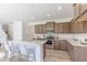 Modern kitchen featuring a central island, stylish bar stools, and stainless steel appliances at 1107 Stubble Run, Danville, IN 46122