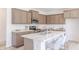 Modern kitchen featuring an island with seating, stainless steel appliances and marble countertops at 1107 Stubble Run, Danville, IN 46122