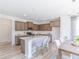 Bright kitchen boasts an island with marble countertops and modern stainless steel appliances at 1107 Stubble Run, Danville, IN 46122