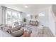 Sunlit living room features modern decor, hardwood floors, and neutral-toned furnishings at 1107 Stubble Run, Danville, IN 46122