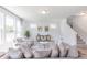 Bright living room with large windows, stylish furniture, and an elegant area rug at 1107 Stubble Run, Danville, IN 46122