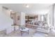 Open concept living room with modern decor, staircase, and view into the kitchen and dining room at 1107 Stubble Run, Danville, IN 46122