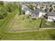 Aerial view of a spacious backyard with a trampoline, playground, and fire pit at 11155 Funny Cide Dr, Noblesville, IN 46060