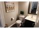 Powder room featuring modern fixtures, neutral paint, contemporary decor, and a vanity with storage space at 11155 Funny Cide Dr, Noblesville, IN 46060