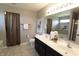 Bathroom featuring a dual sink vanity, a large mirror and tile flooring at 11155 Funny Cide Dr, Noblesville, IN 46060