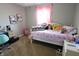 Bedroom with pink curtains, playful decor, desk, and plush toys at 11155 Funny Cide Dr, Noblesville, IN 46060