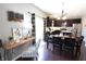 Dining area featuring modern table and chairs, hardwood floors, with a view into the open kitchen at 11155 Funny Cide Dr, Noblesville, IN 46060