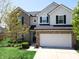Two-story home featuring a brick and vinyl exterior, black shutters, well-maintained landscaping, and an attached two-car garage at 11155 Funny Cide Dr, Noblesville, IN 46060