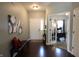 Inviting foyer with hardwood floors, a bench and access to the office at 11155 Funny Cide Dr, Noblesville, IN 46060